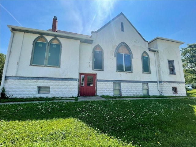 130 W 2nd St, Clearmont, MO 64431 - view of front of home with a chimney, a front lawn, and stucco siding