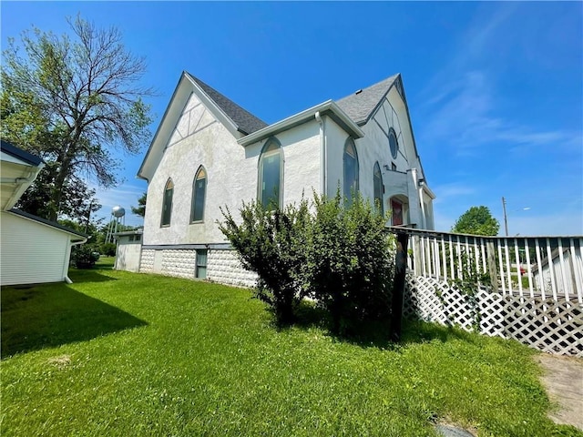 130 W 2nd St, Clearmont, MO 64431 - view of side of home with stucco siding and a yard