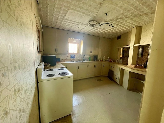130 W 2nd St, Clearmont, MO 64431 - kitchen featuring white electric range oven, light floors, light countertops, and an ornate ceiling