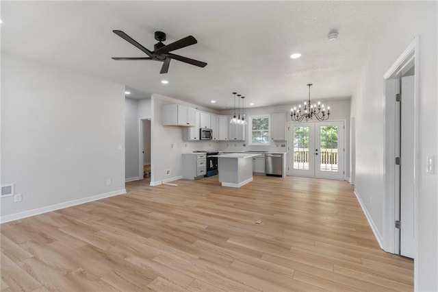 410 E Main St, Richmond, MO 64085 - kitchen with stainless steel appliances, a chandelier, light countertops, open floor plan, and a kitchen island