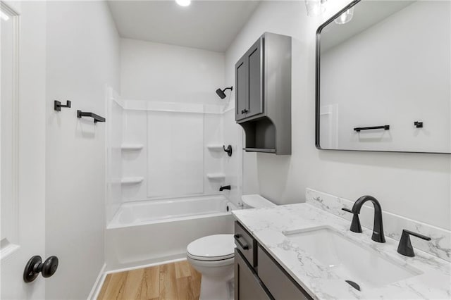 410 E Main St, Richmond, MO 64085 - bathroom featuring vanity, wood finished floors, and shower / bathtub combination