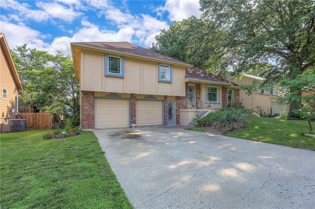 1924 E Sleepy Hollow Dr, Olathe, KS 66062 - split level home featuring concrete driveway, brick siding, a garage, and roof with shingles