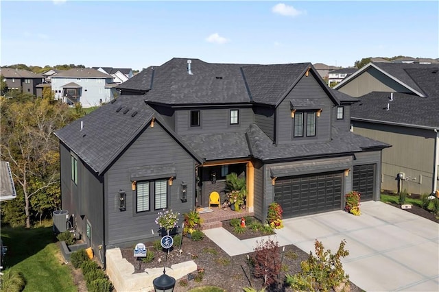 11594 S Zarda Dr, Olathe, KS 66061 - view of front facade featuring driveway, an attached garage, a residential view, and a shingled roof