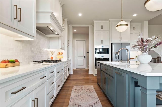 11594 S Zarda Dr, Olathe, KS 66061 - kitchen with stainless steel appliances, white cabinetry, decorative backsplash, dark wood finished floors, and hanging light fixtures