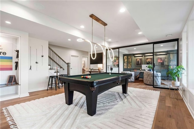 11594 S Zarda Dr, Olathe, KS 66061 - playroom with billiards, wood finished floors, recessed lighting, and a tray ceiling