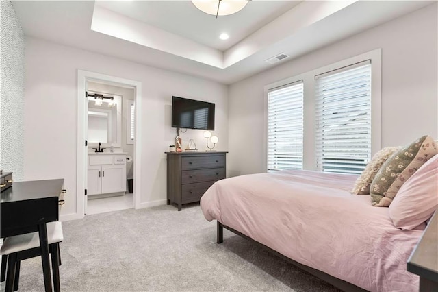 11594 S Zarda Dr, Olathe, KS 66061 - bedroom with a raised ceiling, light carpet, and connected bathroom
