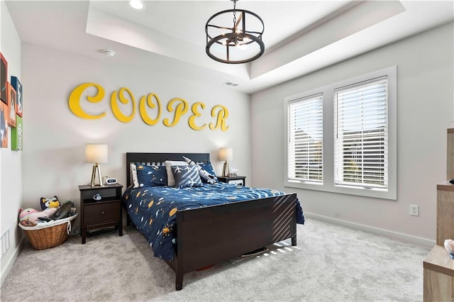 11594 S Zarda Dr, Olathe, KS 66061 - carpeted bedroom featuring a raised ceiling and a chandelier