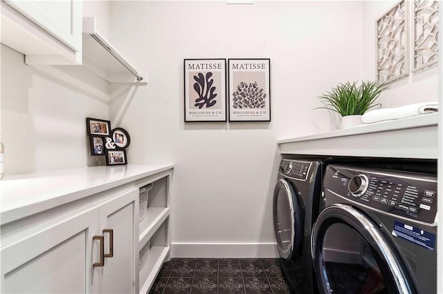 11594 S Zarda Dr, Olathe, KS 66061 - laundry room featuring washing machine and clothes dryer, dark tile patterned floors, and cabinet space