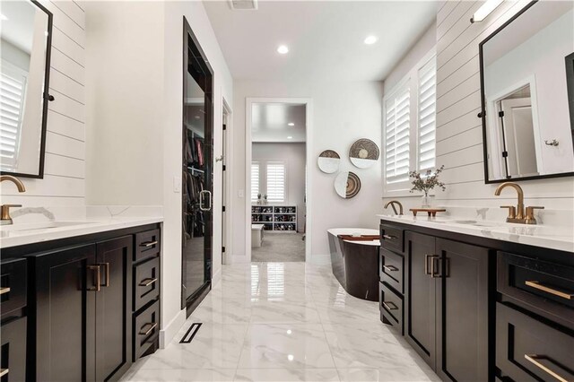 11594 S Zarda Dr, Olathe, KS 66061 - full bath with two vanities, marble tiled floors, a soaking tub, and recessed lighting