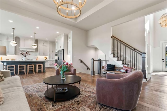11594 S Zarda Dr, Olathe, KS 66061 - living area featuring a chandelier, stairway, wood finished floors, and recessed lighting