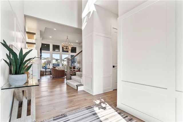 11594 S Zarda Dr, Olathe, KS 66061 - entrance foyer with a chandelier, stairway, a decorative wall, wood finished floors, and recessed lighting