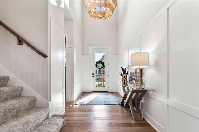 11594 S Zarda Dr, Olathe, KS 66061 - entryway with a towering ceiling, stairway, wood finished floors, and a decorative wall
