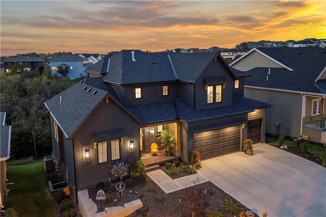 11594 S Zarda Dr, Olathe, KS 66061 - view of front of house with driveway, roof with shingles, a garage, and a residential view