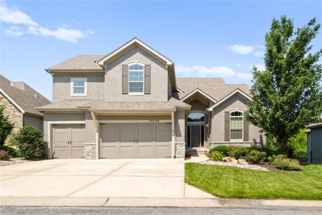 13428 W 172nd St, Overland Park, KS 66221 - view of front of property featuring stucco siding, an attached garage, concrete driveway, and a front yard