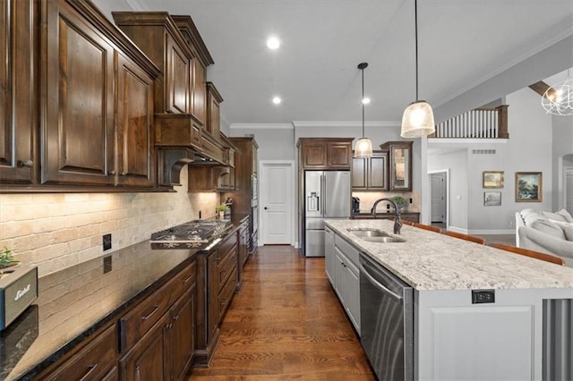 13428 W 172nd St, Overland Park, KS 66221 - kitchen featuring stainless steel appliances, crown molding, dark brown cabinets, backsplash, and light stone counters