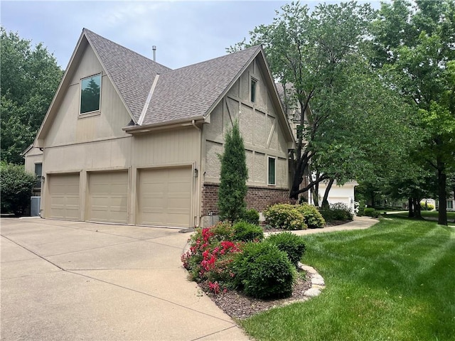 13108 Windsor Cir, Leawood, KS 66209 - view of side of home featuring roof with shingles, a lawn, driveway, a garage, and brick siding