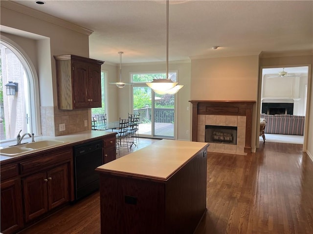 13108 Windsor Cir, Leawood, KS 66209 - kitchen with dishwasher, a tile fireplace, crown molding, a ceiling fan, and dark wood-style flooring