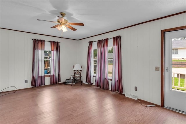 310 E Clay St, Carrollton, MO 64633 - empty room with wood finished floors, crown molding, and ceiling fan