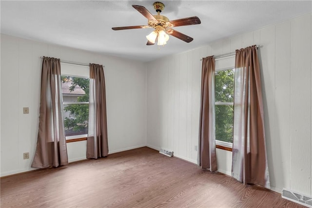 310 E Clay St, Carrollton, MO 64633 - unfurnished room with wood finished floors and a ceiling fan