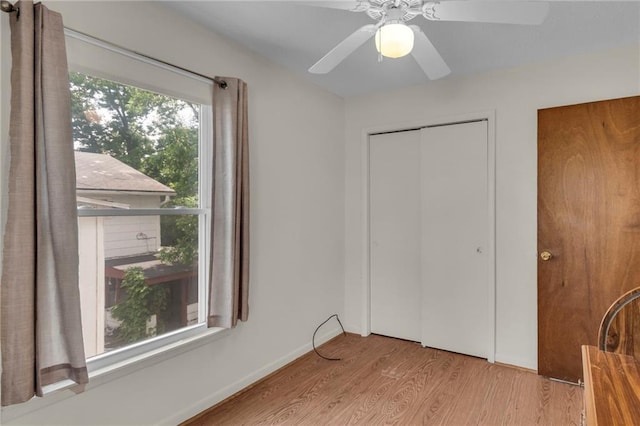 310 E Clay St, Carrollton, MO 64633 - unfurnished bedroom featuring wood finished floors and ceiling fan