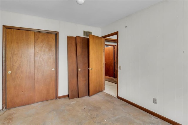 310 E Clay St, Carrollton, MO 64633 - unfurnished bedroom with concrete floors and a closet