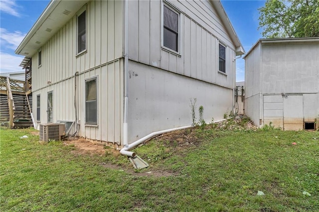 310 E Clay St, Carrollton, MO 64633 - view of home's exterior featuring board and batten siding and a lawn
