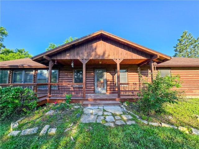2359 Gp Rd, Ks, KS 66850 - rear view of house with faux log siding, covered porch, and roof with shingles