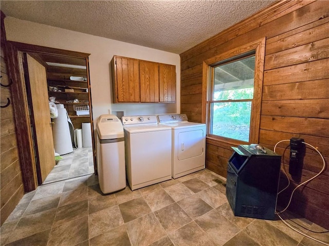 2359 Gp Rd, Ks, KS 66850 - laundry area with cabinet space, separate washer and dryer, wooden walls, and a textured ceiling
