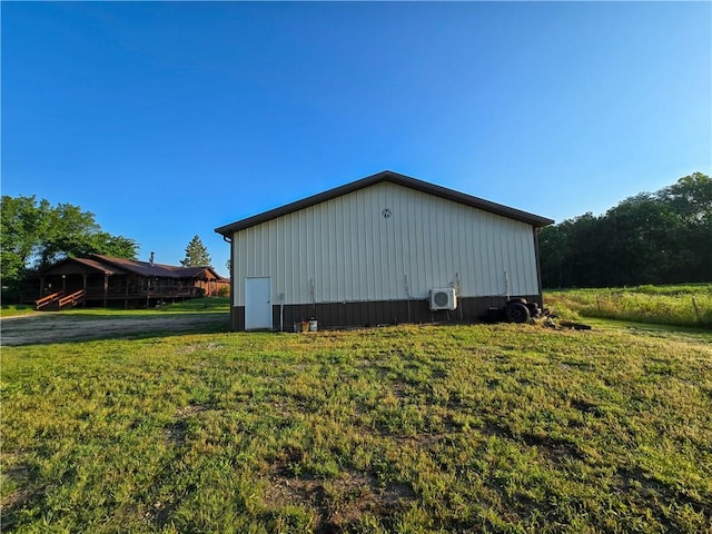 2359 Gp Rd, Ks, KS 66850 - view of side of home featuring a lawn, an outbuilding, and board and batten siding