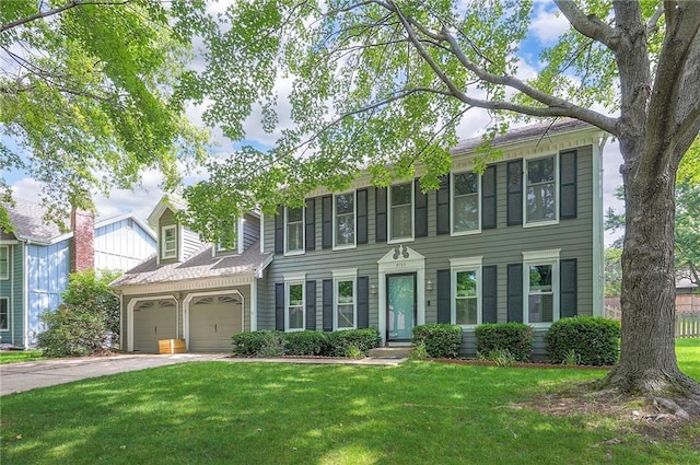 9705 N Virginia Ave, Kansas City, MO 64155 - colonial house featuring a front yard, driveway, and an attached garage