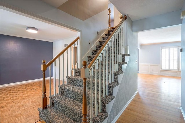 9705 N Virginia Ave, Kansas City, MO 64155 - staircase featuring ornamental molding, wood finished floors, and wainscoting