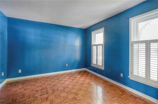 9705 N Virginia Ave, Kansas City, MO 64155 - spare room featuring a textured ceiling and baseboards