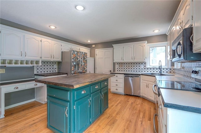 9705 N Virginia Ave, Kansas City, MO 64155 - kitchen with appliances with stainless steel finishes, white cabinets, wooden counters, light wood finished floors, and recessed lighting