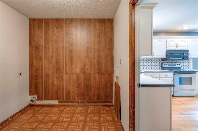 9705 N Virginia Ave, Kansas City, MO 64155 - laundry area featuring light wood-style floors