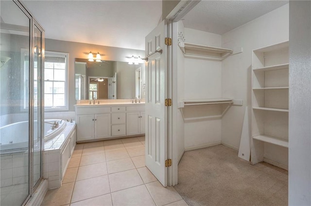 9705 N Virginia Ave, Kansas City, MO 64155 - bathroom featuring double vanity, a tub with jets, a stall shower, tile patterned flooring, and a ceiling fan