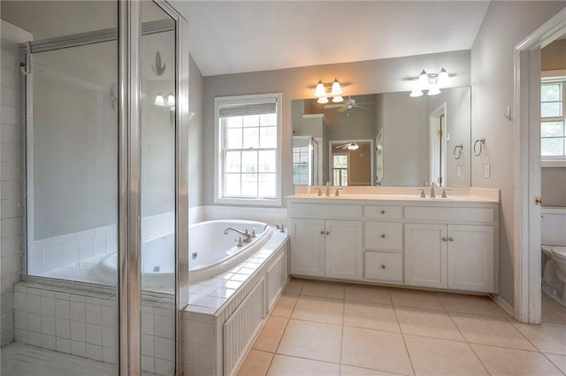 9705 N Virginia Ave, Kansas City, MO 64155 - bathroom with double vanity, a whirlpool tub, plenty of natural light, and ceiling fan