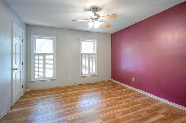 9705 N Virginia Ave, Kansas City, MO 64155 - spare room featuring a ceiling fan and light wood-style floors
