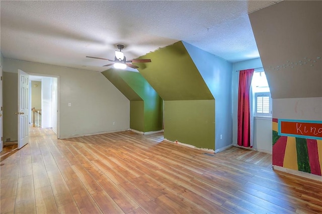 9705 N Virginia Ave, Kansas City, MO 64155 - bonus room with a ceiling fan, lofted ceiling, light wood finished floors, and a textured ceiling