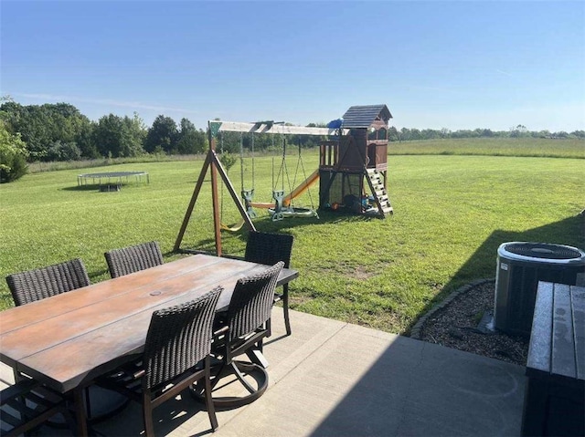3632 SE 228th St, Lathrop, MO 64465 - view of patio / terrace with a playground, a trampoline, and outdoor dining space