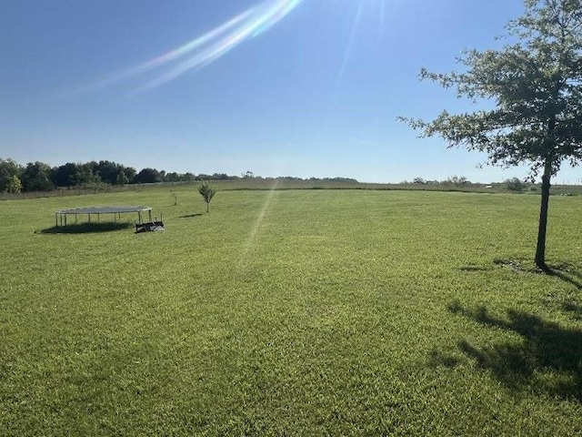 3632 SE 228th St, Lathrop, MO 64465 - view of grassy yard featuring a trampoline and a rural view
