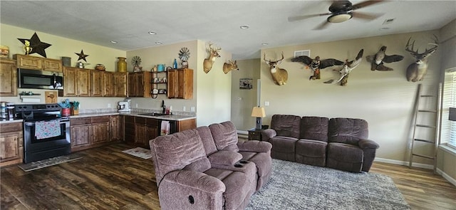 3632 SE 228th St, Lathrop, MO 64465 - kitchen featuring stainless steel microwave, range with electric cooktop, dark wood-style floors, light countertops, and ceiling fan
