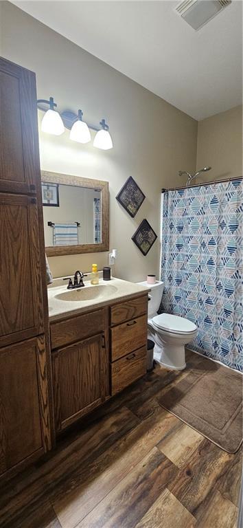 3632 SE 228th St, Lathrop, MO 64465 - full bathroom with wood finished floors, vanity, and a shower with curtain