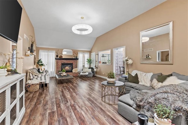 6809 W 156th St, Overland Park, KS 66223 - living area featuring vaulted ceiling, a fireplace, and wood finished floors