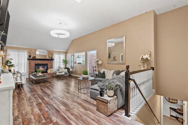 6809 W 156th St, Overland Park, KS 66223 - living room with wood finished floors, lofted ceiling, and a brick fireplace