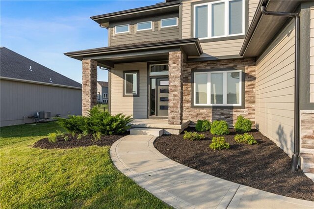 3113 SW Arboridge Dr, Lees Summit, MO 64081 - view of exterior entry with a porch, stone siding, and a yard