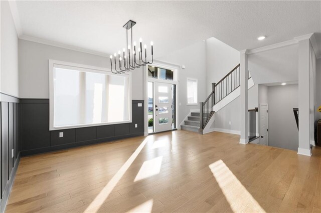 3113 SW Arboridge Dr, Lees Summit, MO 64081 - foyer featuring light wood finished floors, stairway, recessed lighting, a chandelier, and crown molding
