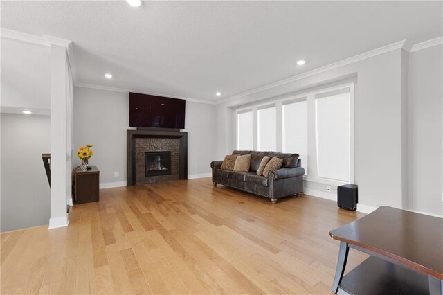 3113 SW Arboridge Dr, Lees Summit, MO 64081 - living room with light wood finished floors, crown molding, recessed lighting, and a glass covered fireplace