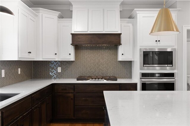 3113 SW Arboridge Dr, Lees Summit, MO 64081 - kitchen featuring stainless steel appliances, white cabinetry, and dark brown cabinets