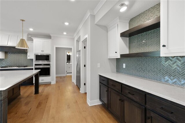 3113 SW Arboridge Dr, Lees Summit, MO 64081 - kitchen with stainless steel appliances, crown molding, open shelves, white cabinets, and tasteful backsplash