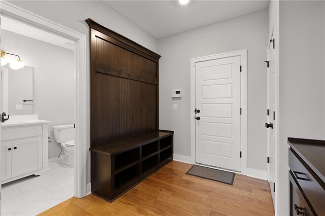 3113 SW Arboridge Dr, Lees Summit, MO 64081 - mudroom featuring baseboards and a sink
